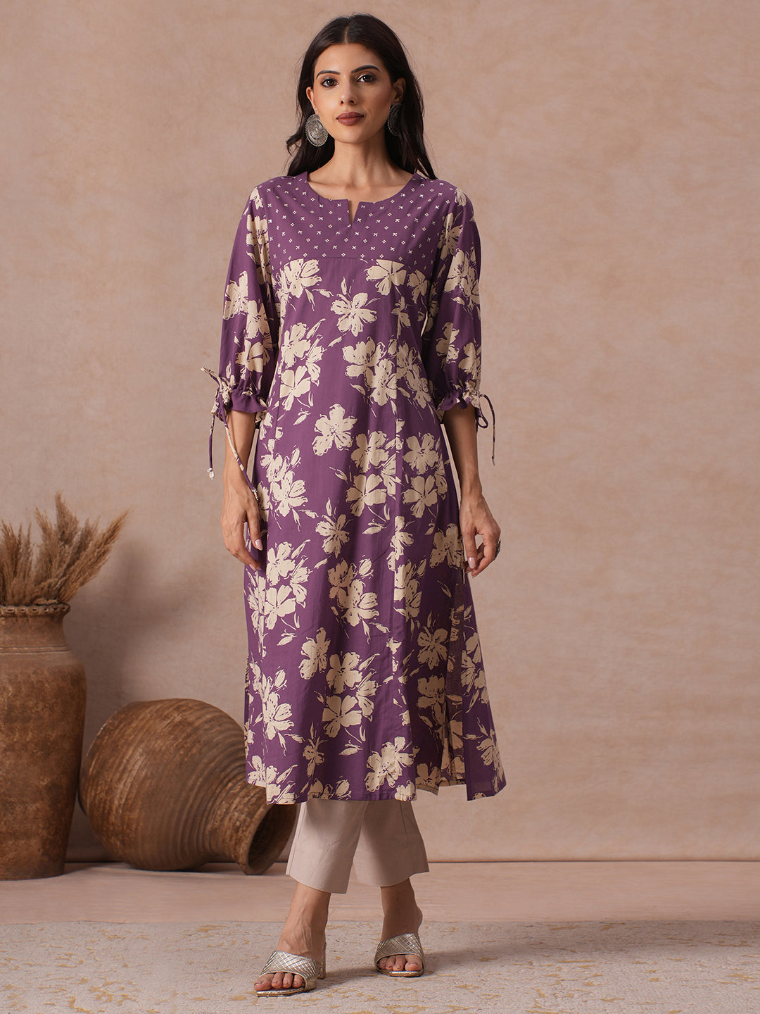 A-line Printed Cotton Kurta with Hand Sequined Yoke and Stylish Tie-Up Sleeves.
