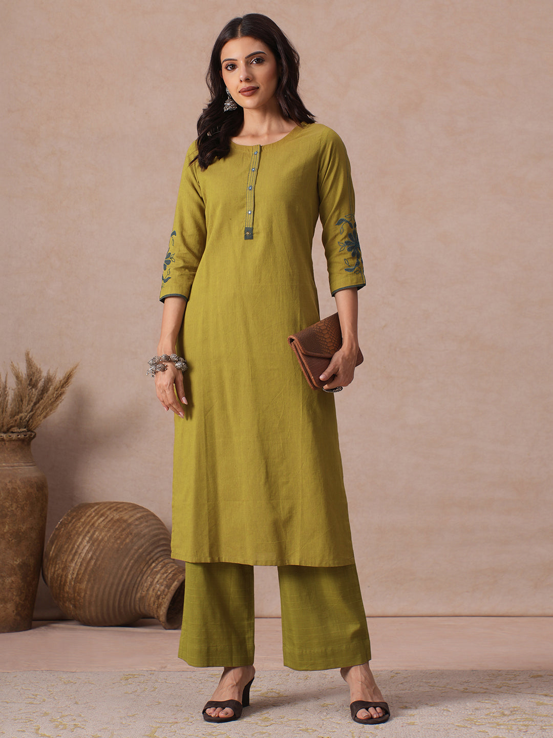 Straight Fit Cotton Kurta with Handwork Placket and Machine Applique Sleeve Detail.