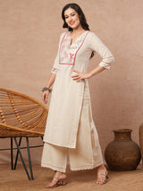 Straight fit solid kurta set with a wrap half embroidery and cotton flex palazzo.