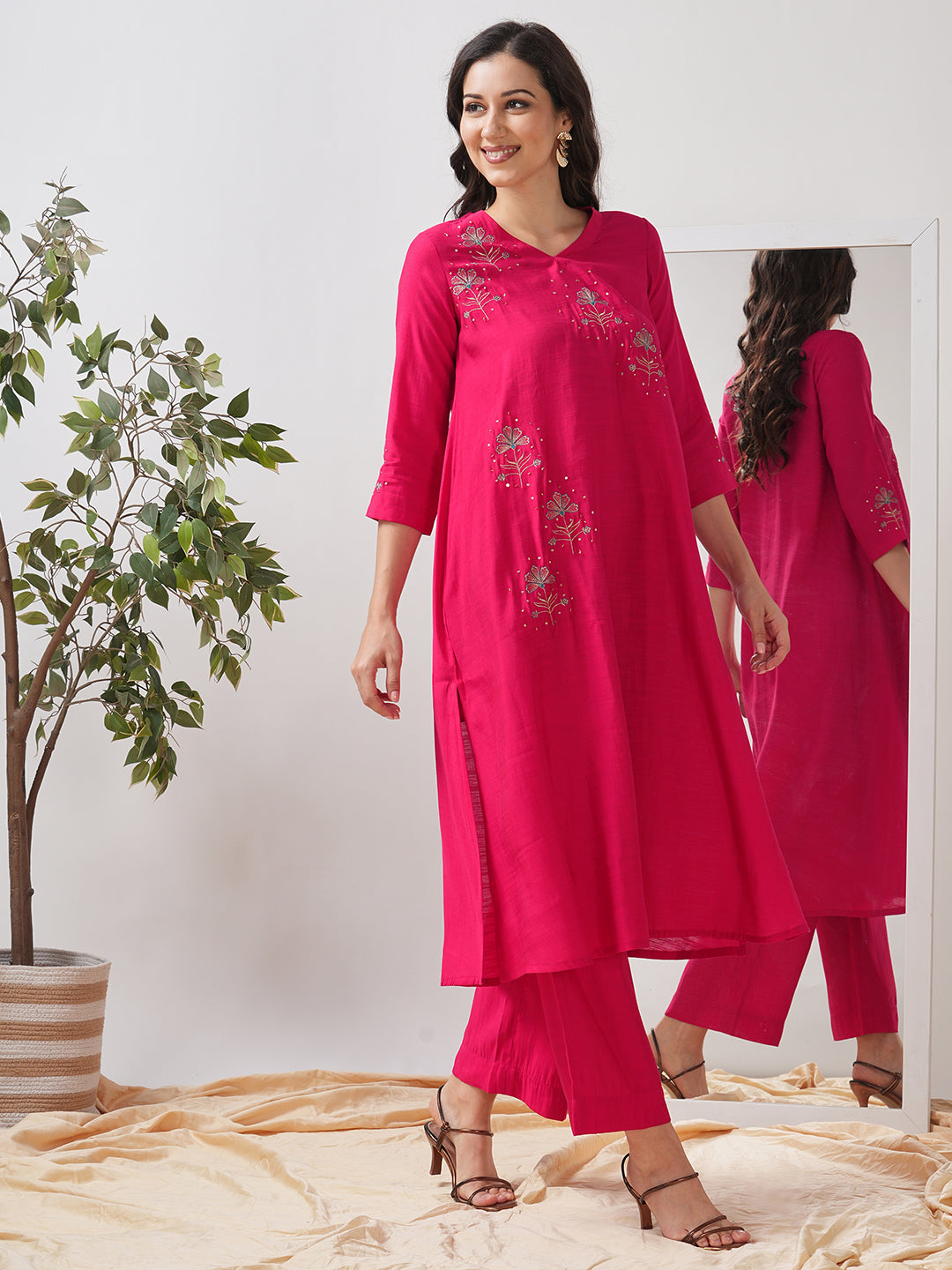 Party Edit- A tent fit kurta set with placement embroidery on the front and sleeves, paired with palazzo.