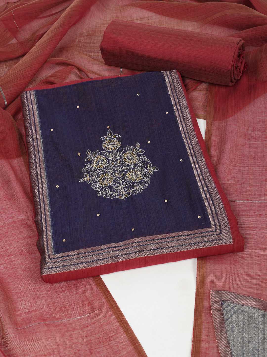 Unstitched suit set in elegant tussar silk featuring a contrast blue yoke with delicate zari work.(Maroon)