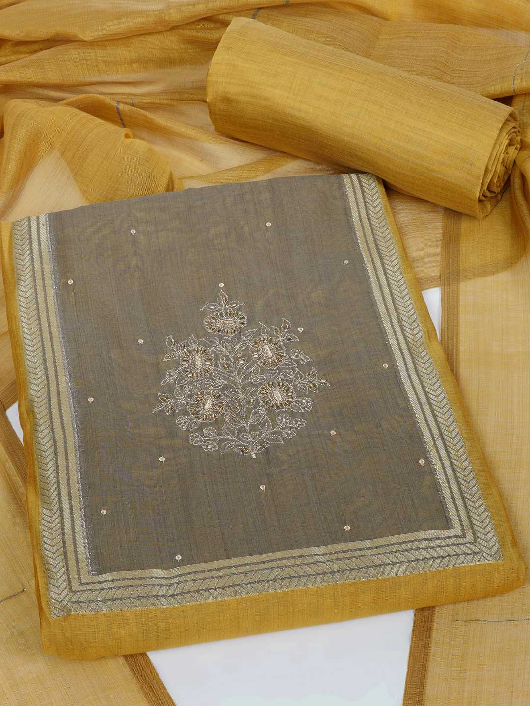 Unstitched suit set in elegant tussar silk featuring a contrast blue yoke with delicate zari work.(Yellow)