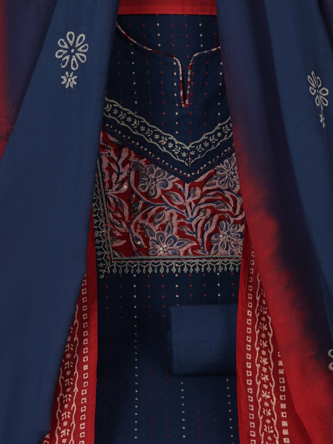 Unstitched suit set crafted in dobby fabric features a handcrafted Kalamkari printed patch.