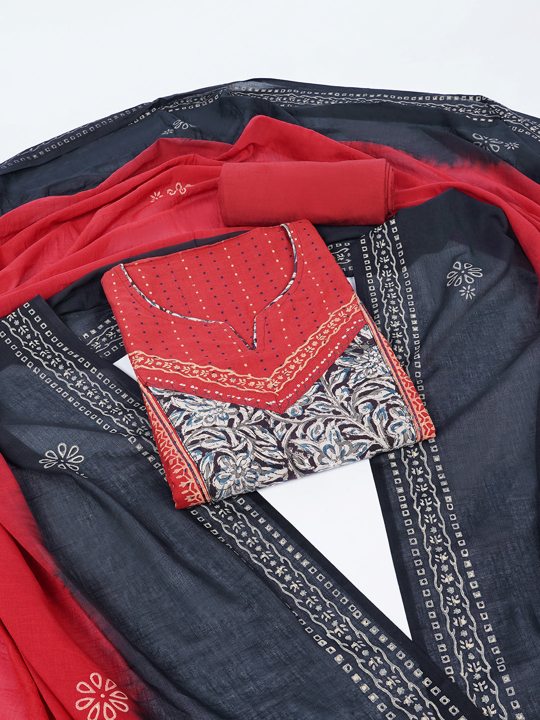 Unstitched suit set crafted in dobby fabric features a handcrafted Kalamkari printed patch.