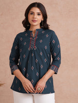 Printed short top with contrast fabric detailing with metal accessories.