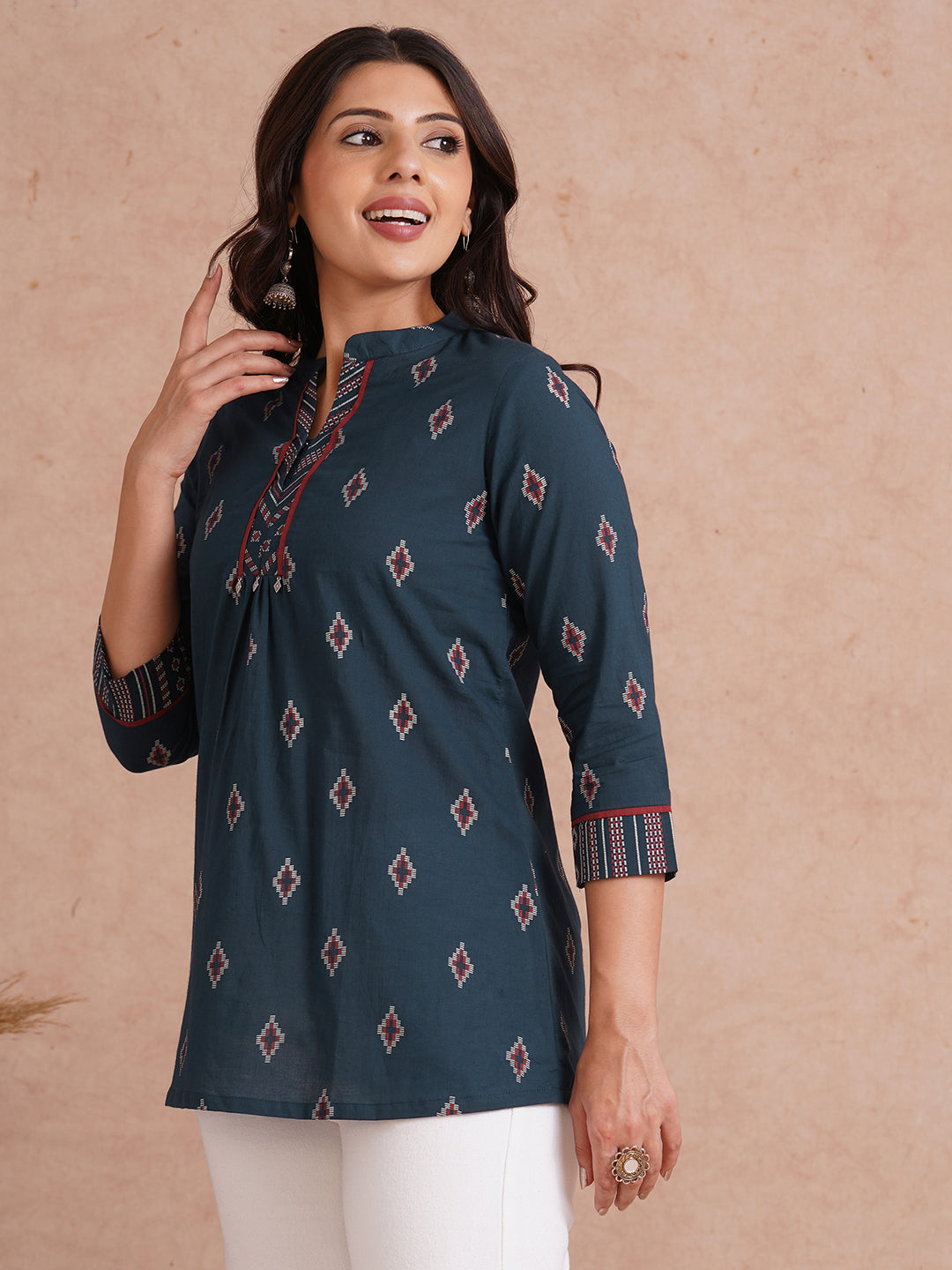 Printed short top with contrast fabric detailing with metal accessories.