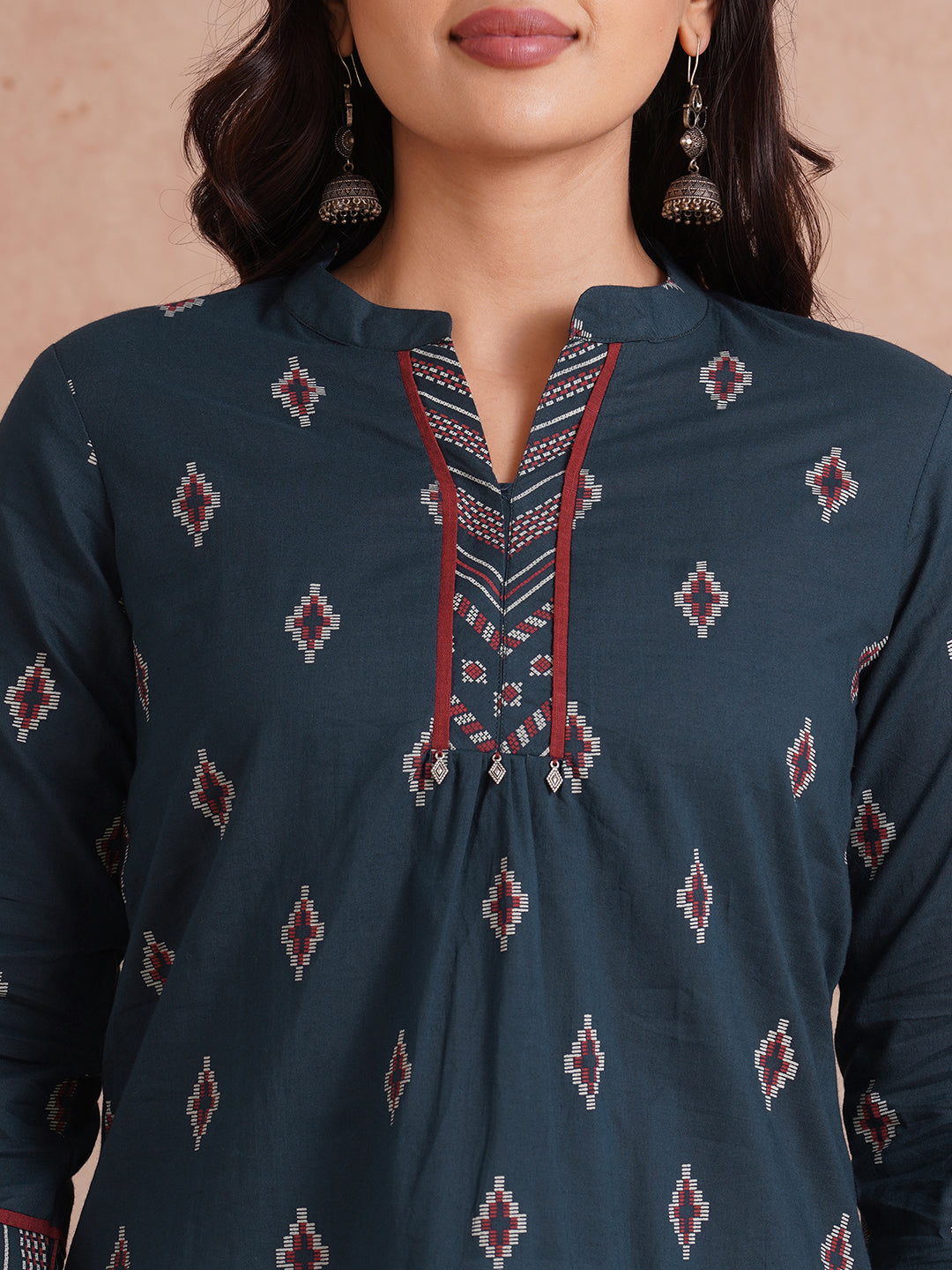 Printed short top with contrast fabric detailing with metal accessories.