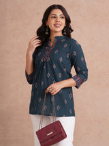 Printed short top with contrast fabric detailing with metal accessories.