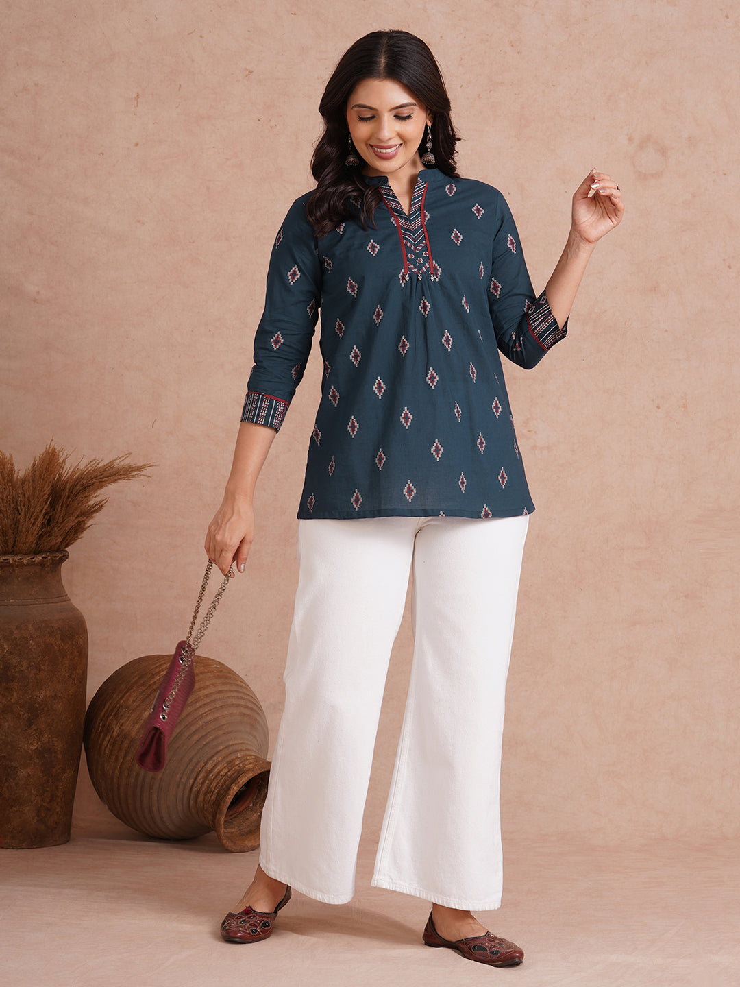 Printed short top with contrast fabric detailing with metal accessories.