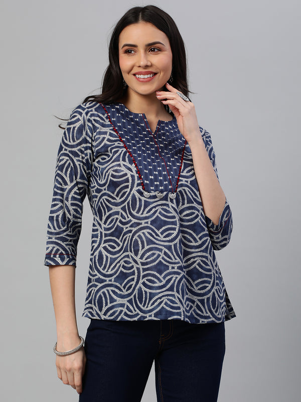 Khoobsurat - A printed tunic with a yoke detail embellished with metal trim.